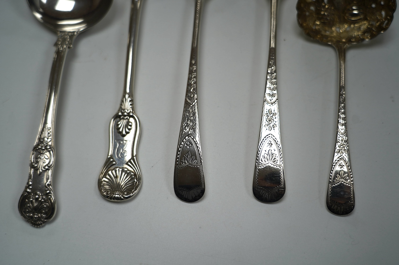 A pair of George III silver berry spoons, London, 1804, together with three other spoons, including a Georgian Scottish table spoon and a George III silver berry sifter spoon, Eley, Fearn & Chawner, London, 1809, 10.6oz.